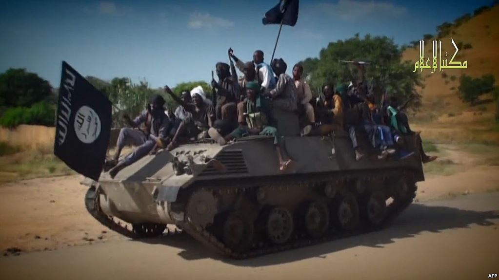 FILE PHOTO: This picture of Boko Haram fighters celebrating on a tank seized from Nigerian soldiers is not related to the attacks mentioned in this story.