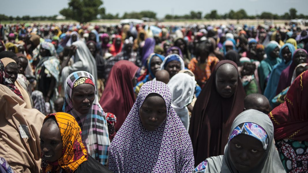 In this photo taken on women and children queuing to enter one of the UNICEF nutrition clinics at the Muna makeshift camp which houses more than 16,000 IDPs (Internally Displaced Persons) on the outskirts of Maiduguri, Borno State, northeastern Nigeria. Aid agencies have long warned about the risk of food shortages in northeast Nigeria because of the conflict, which has killed at least 20,000 since 2009 and left more than 2.6 million homeless. In July, the United Nations said nearly 250,000 children under five could suffer from severe acute malnutrition this year in Borno state alone and one in five -- some 50,000 -- could die. / AFP PHOTO / STEFAN HEUNIS