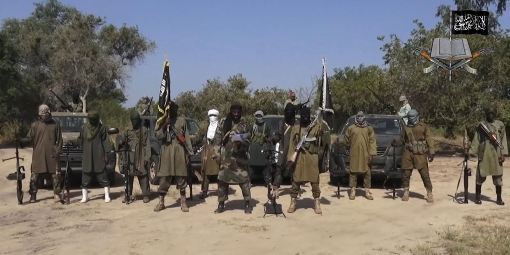 FILE - In this file image taken from video released late Friday evening, Oct. 31, 2014, by Boko Haram, Abubakar Shekau, centre, the leader of Nigeria's Islamic extremist group. Boko Haram fighters have shot or burned to death about 90 civilians and wounded 500 in ongoing fighting in a Cameroonian border town near Nigeria, officials in Cameroon said Thursday, Feb. 5, 2015. (AP Photo/Boko Haram,File)