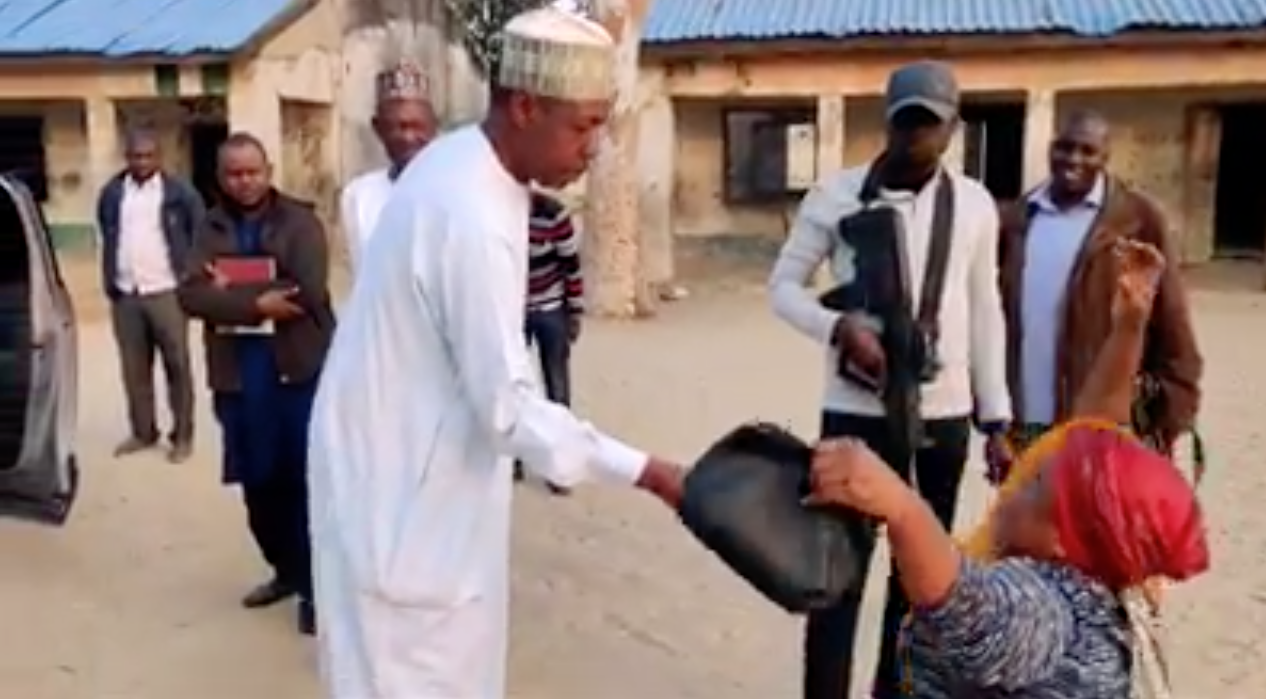 Governor Babagana Umara Zulum of Borno State gives teacher Mrs Obiageli Mazi a N100,000 reward for dedication to duty