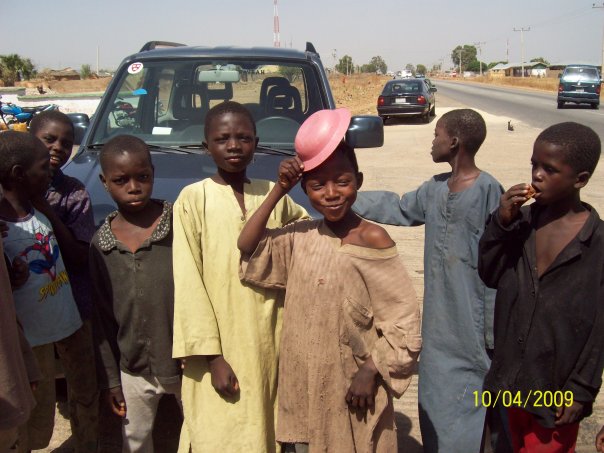 FILE PHOTO: Almajiris hanging around a filling station and begging in Magam Huguma, Bauchi State. Credit: Mustapha Shehu Mustash