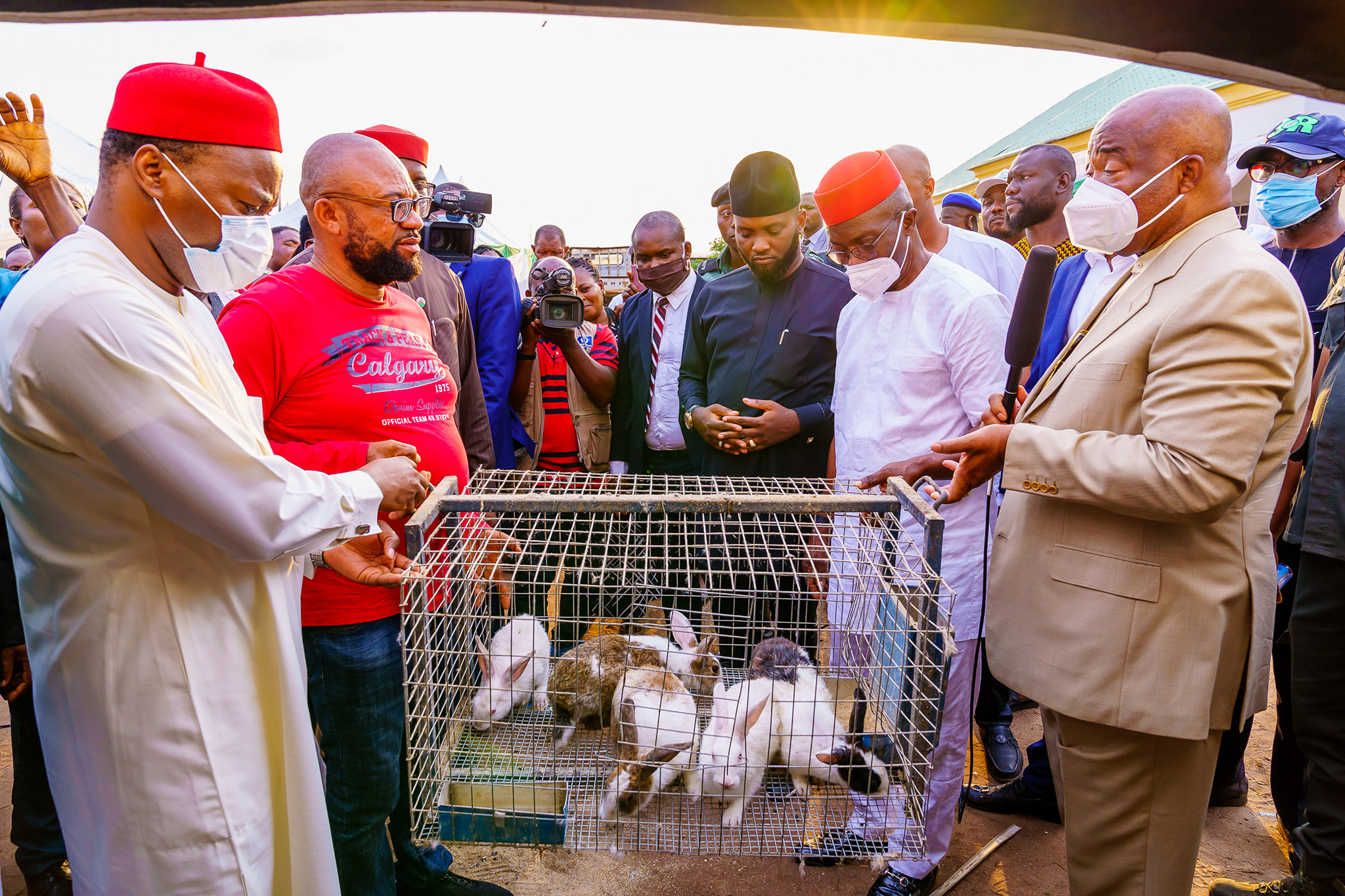 Governor Hope Uzodinma (first right) handing over rabbits to one of the beneficiaries