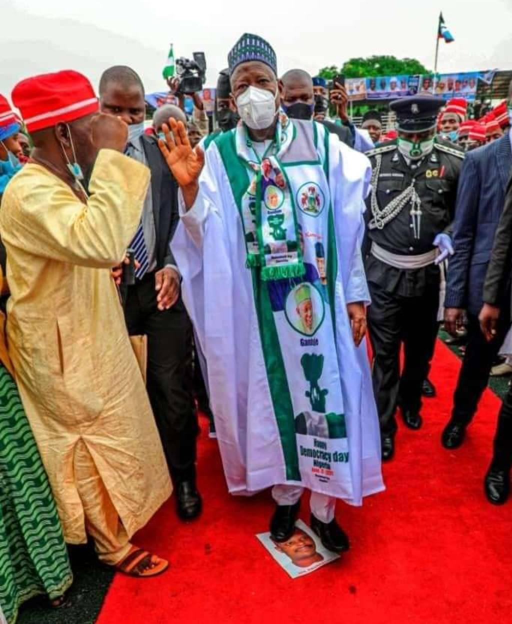 Ganduje steps on Kwankwaso's picture at a political rally