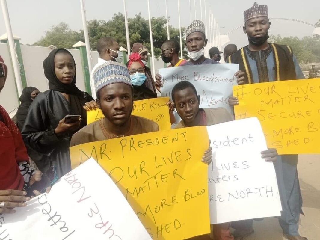 Some protesters holding placards in Kano