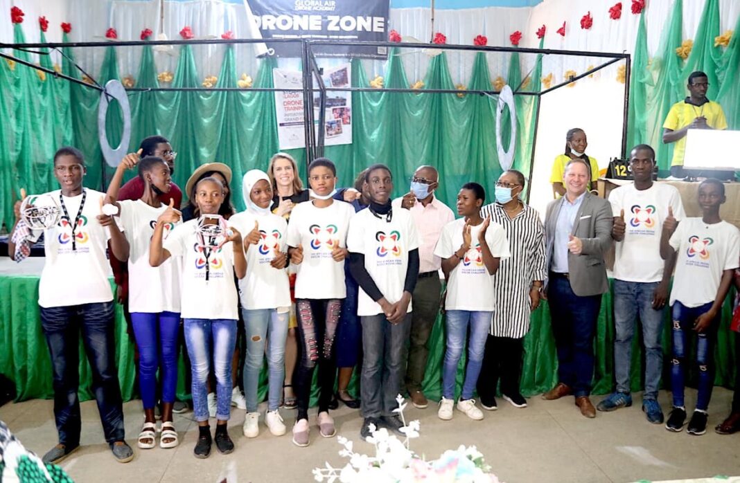 The winning Pace Setters Team from Ijaiye Housing Estate Senior Grammar School in a group photograph with U.S. Consulate Public Affairs Officer Stephen Ibelli (third right) and U.S. Consulate Deputy Public Affairs Officer Jenny Foltz (second row, third left) with Lagos State Commissioner for Education Folasade Adefisayo during the closing ceremony of the drone soccer competition in Lagos on Saturday.