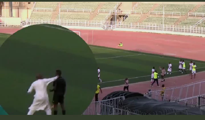 Kano Pillars chairman Surajo Jambul (in white) hitting assistant referee