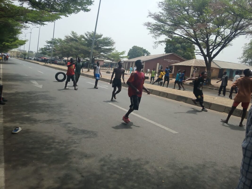 The youth playing football on the road