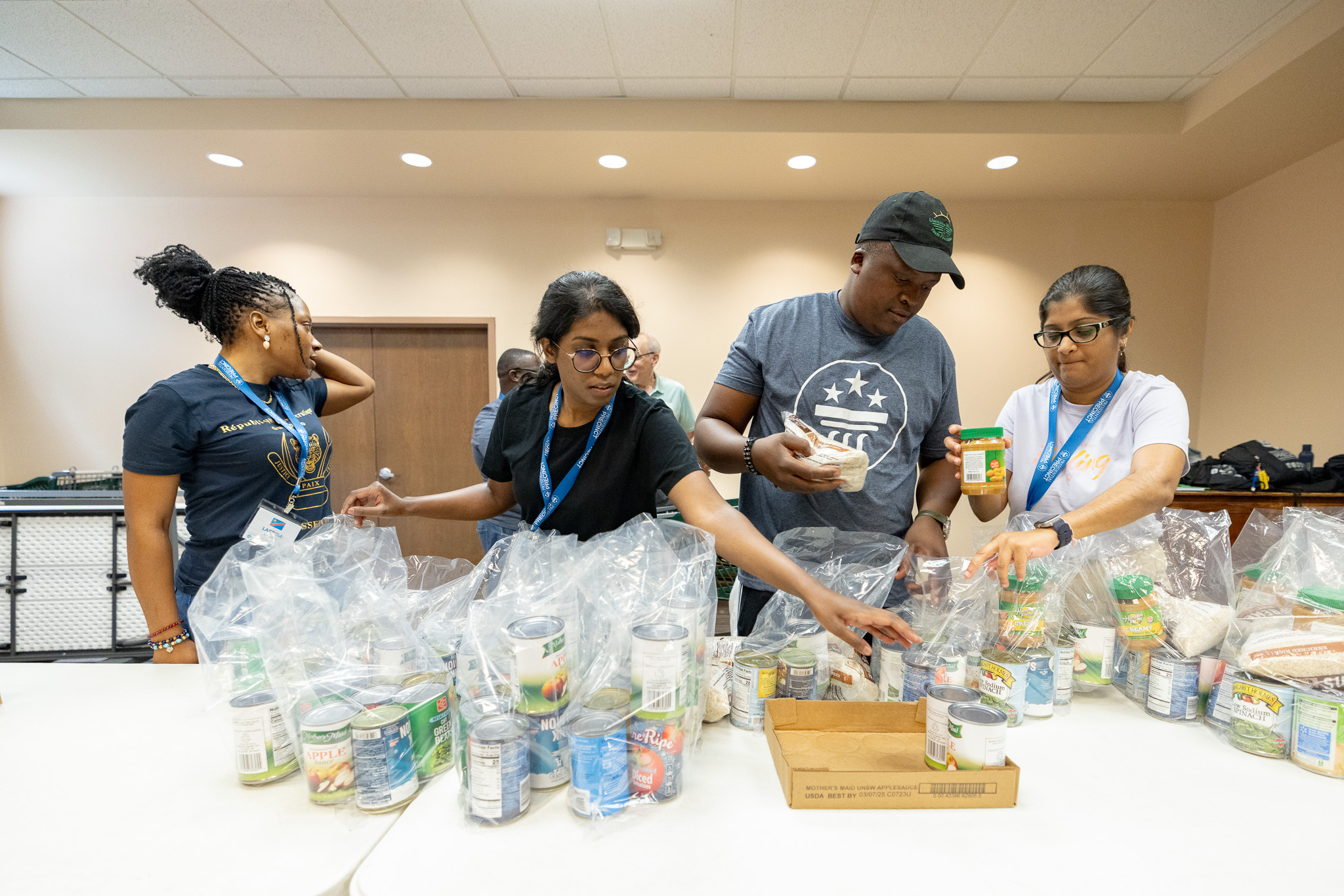 Mandela Washington Fellows at the Presidential Precinct packaging food items at the Grove Outreach Center for distribution to the Needing