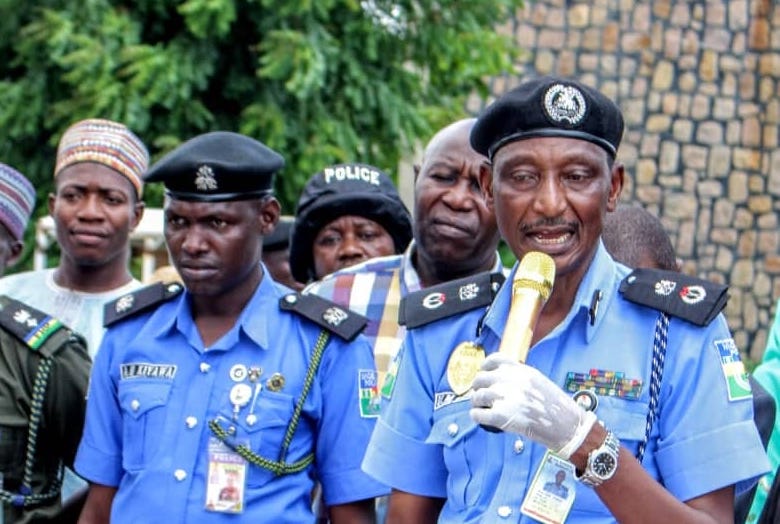 Kano CP Hussaini Gumel holding a microphone.