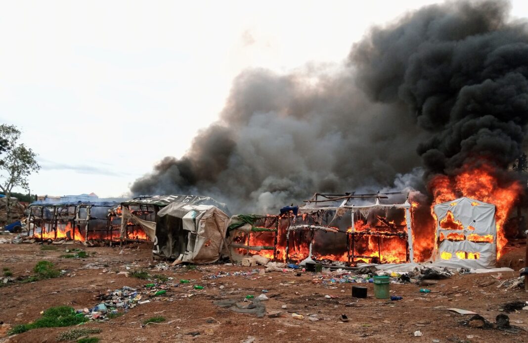 Officials of Abuja Environmental Protection Board destroying illegal structures along A.E Ekukinam Street close to Utako Market in Abuja