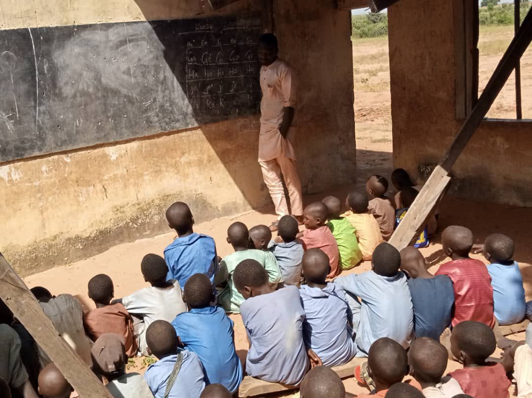 A teacher in a classroom at Komi Primary School