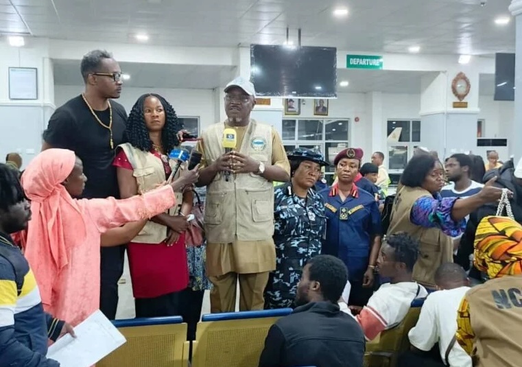 Some deportees from Turkiye with Federal Government officials at the Nnamdi Azikiwe International Airport, Abuja on Friday