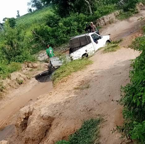A pickup truck stuck on the dilapidated road leading to Ajaga Community