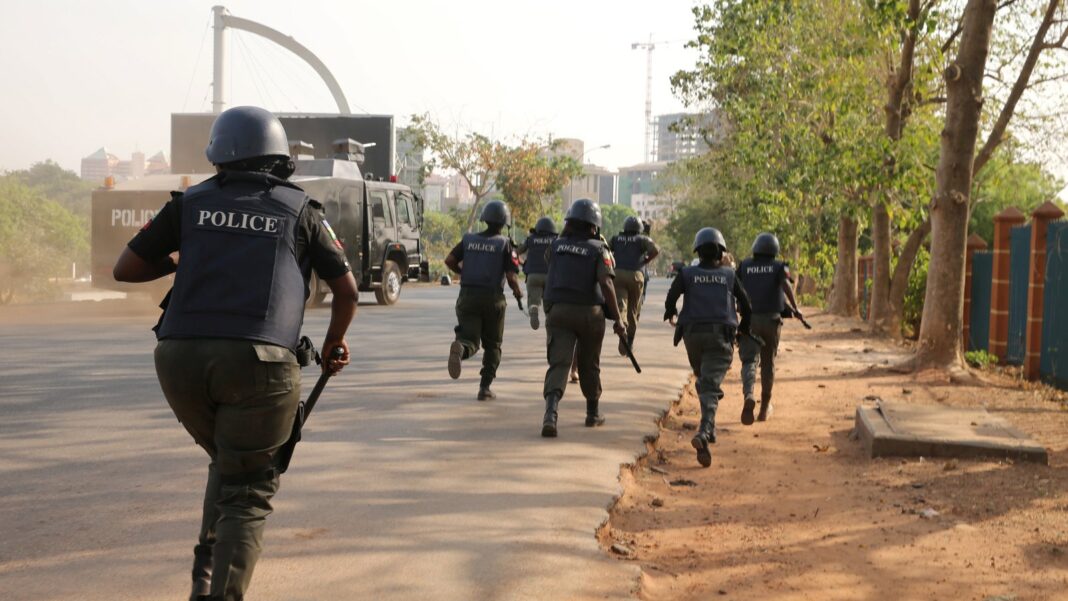FILE PHOTO: Policemen running